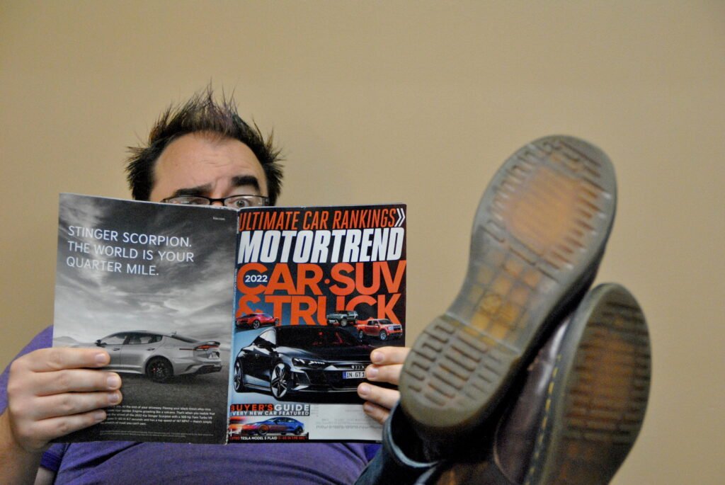 Producer Mike reading a car magazine.