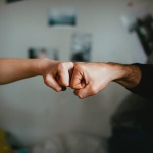 Two hands fist bumping.