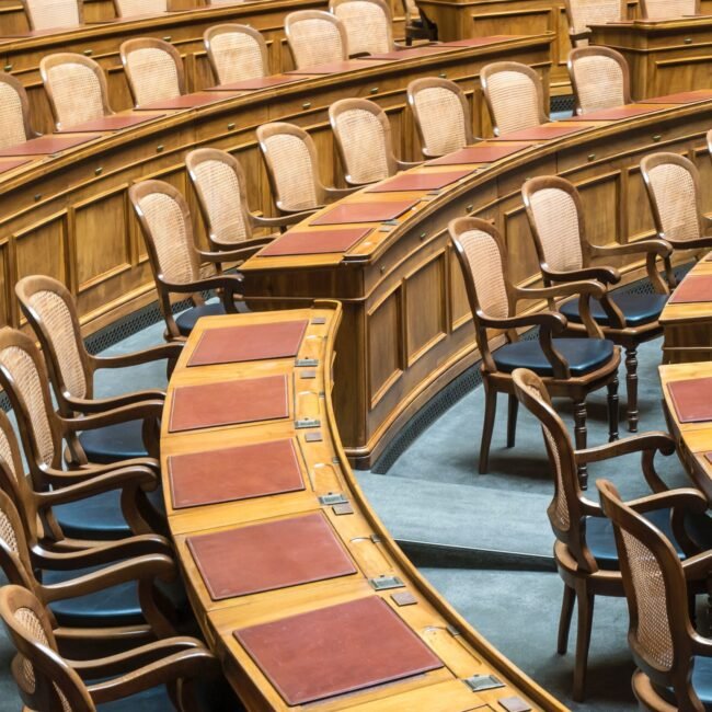 Room with chairs and tables for governmental staff to meet.