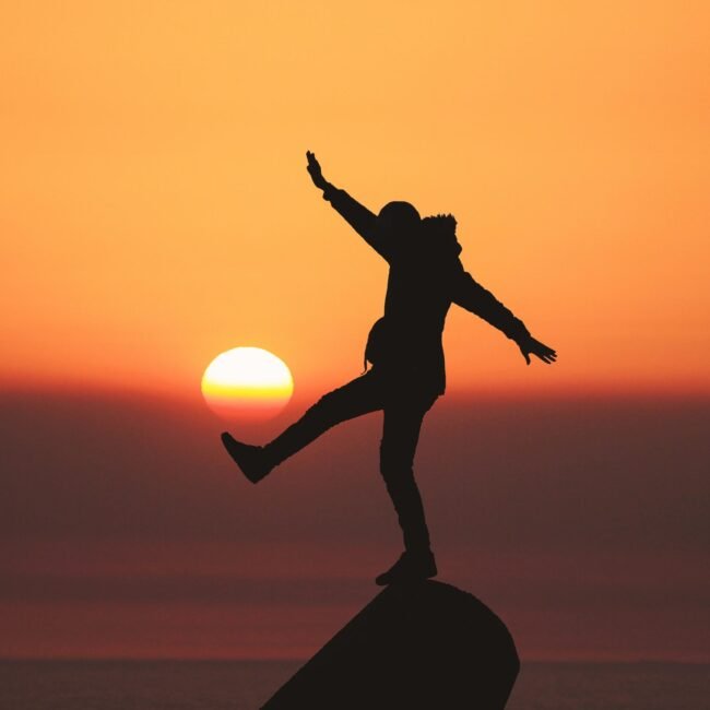 Silhouette of a person in front of sunset.