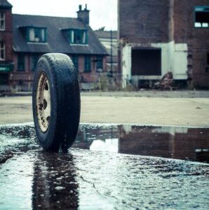 Tire outside in puddle.