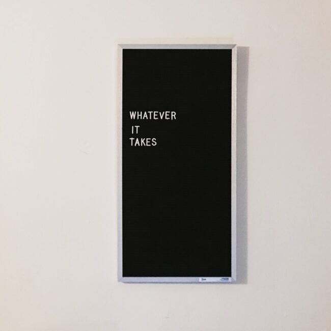 Black word board with "Whatever it takes" written.